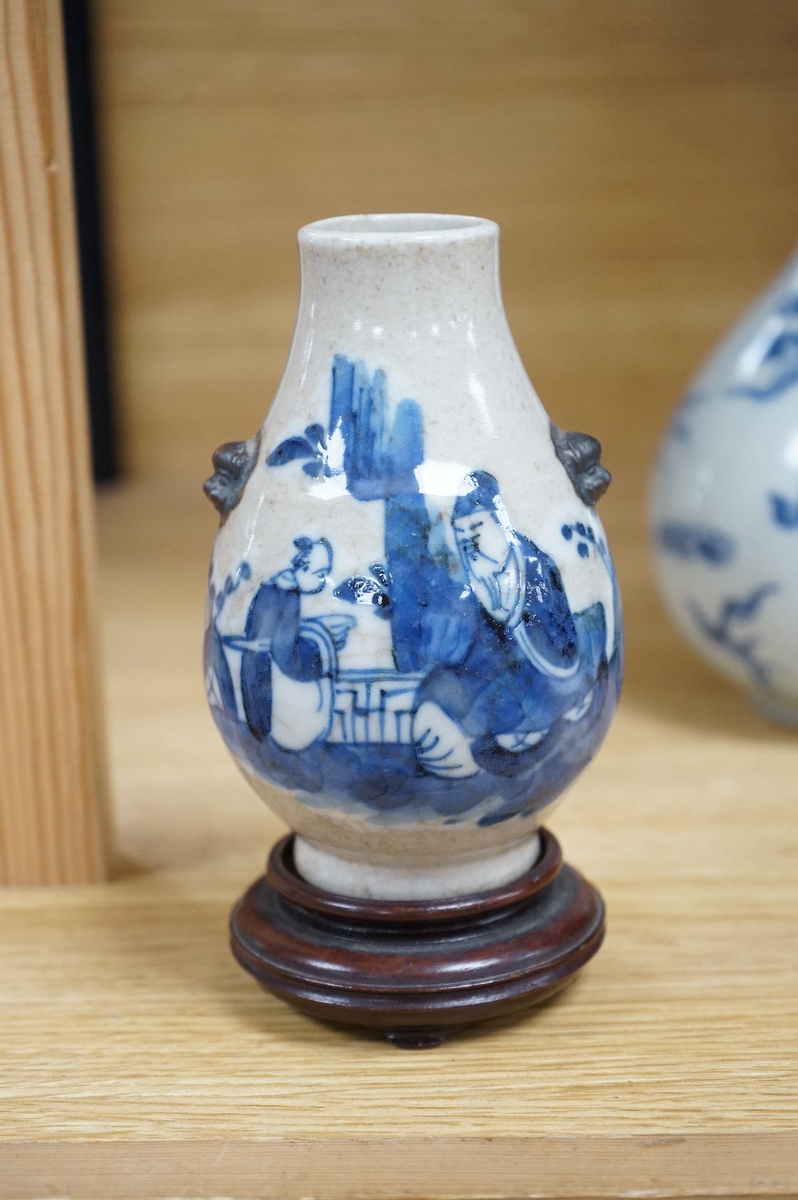 A Chinese blue and white bottle vase, a crackle glaze vase and a Tibetan copper and brass ‘monk’ cap’ ewer (3), tallest 21cm